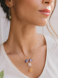 Necklace featuring a pair of swallows, a flower, and an orange><noscript><img width=