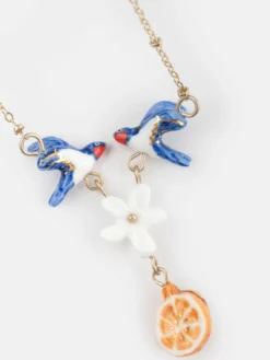 Necklace featuring a pair of swallows, a flower, and an orange><noscript><img width=